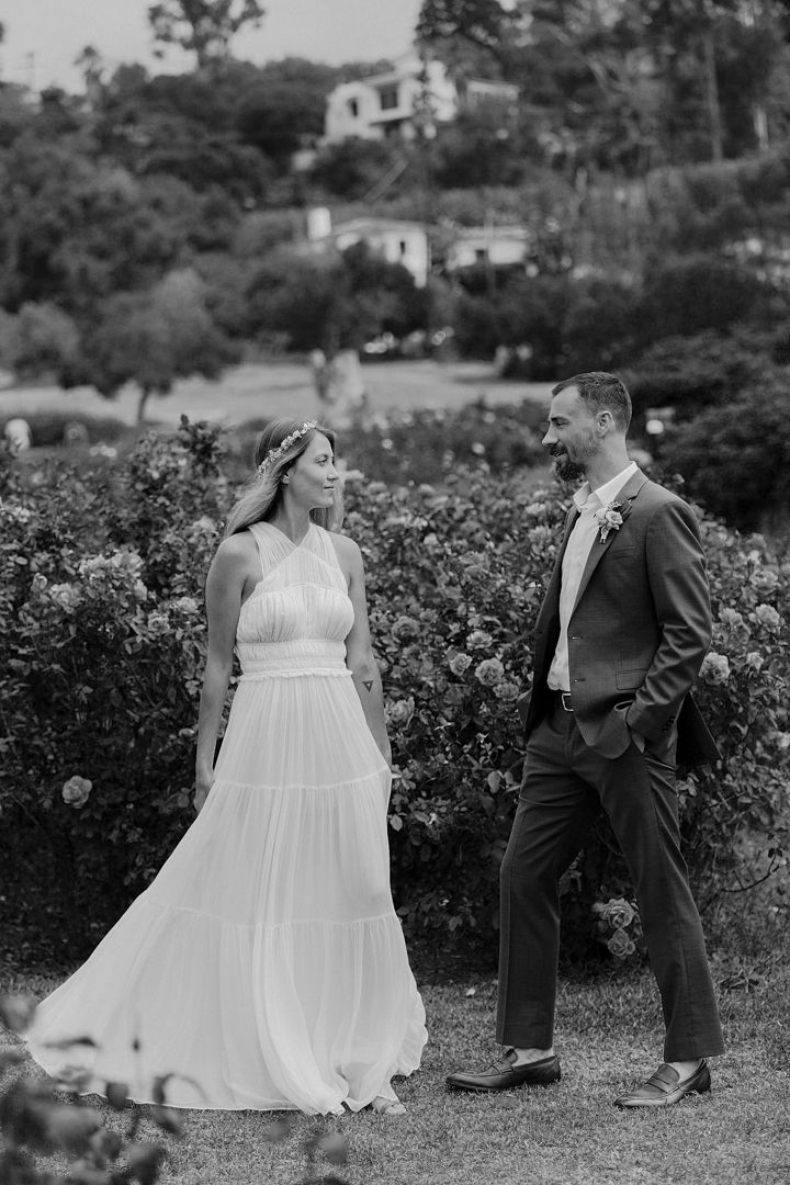 A series of black and white wedding photos showing a couple in formal attire posing together in a garden setting.