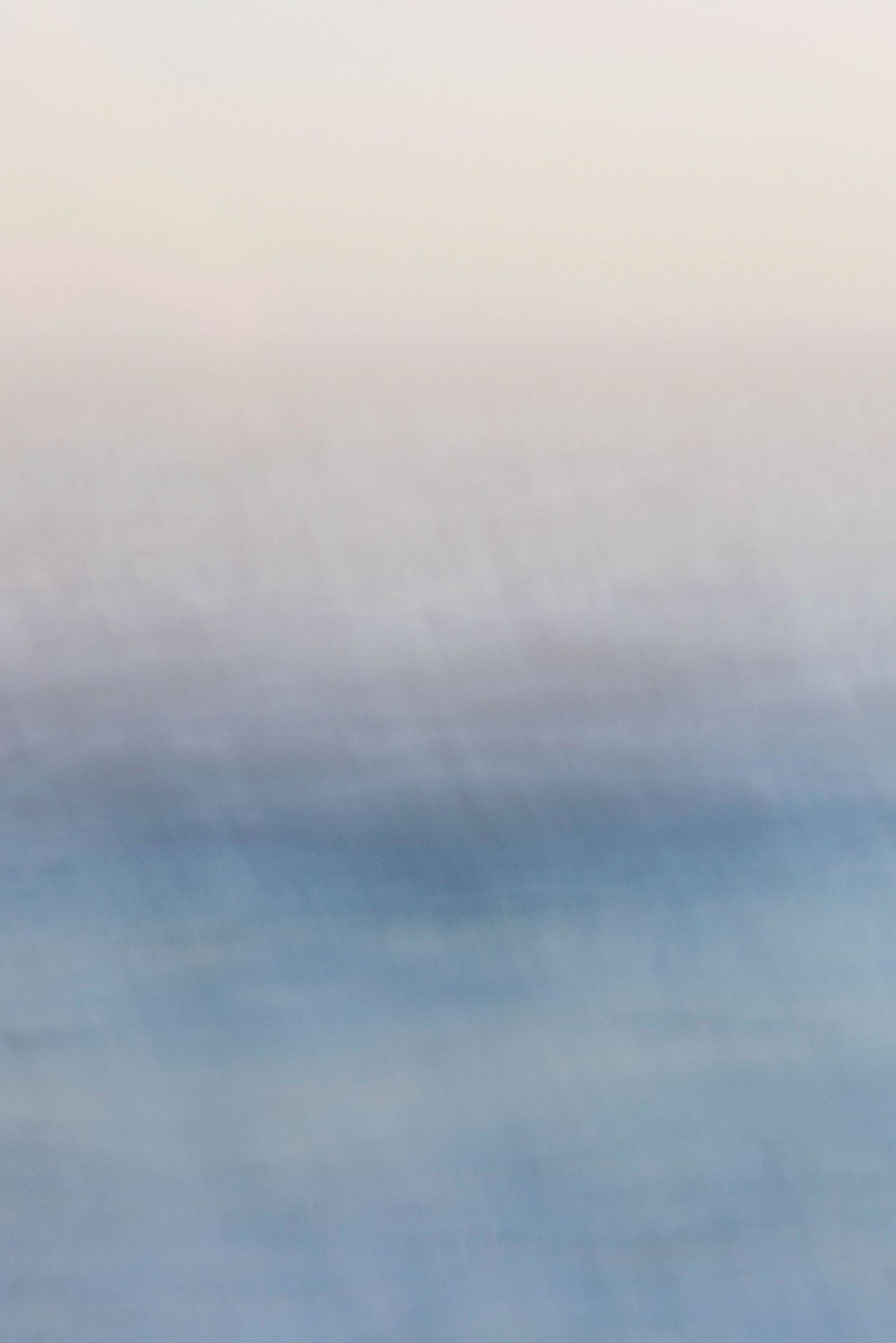 A soft and dreamy abstract background with blended shades of light blue and white creating a peaceful atmosphere.