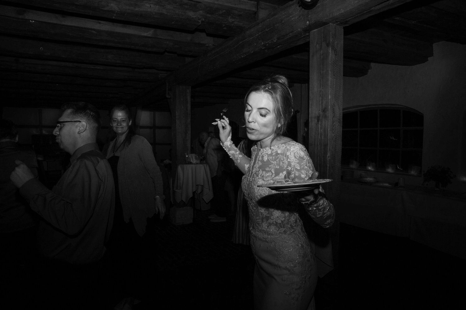 People dance together in a dimly lit room during what appears to be a social dance gathering or event.