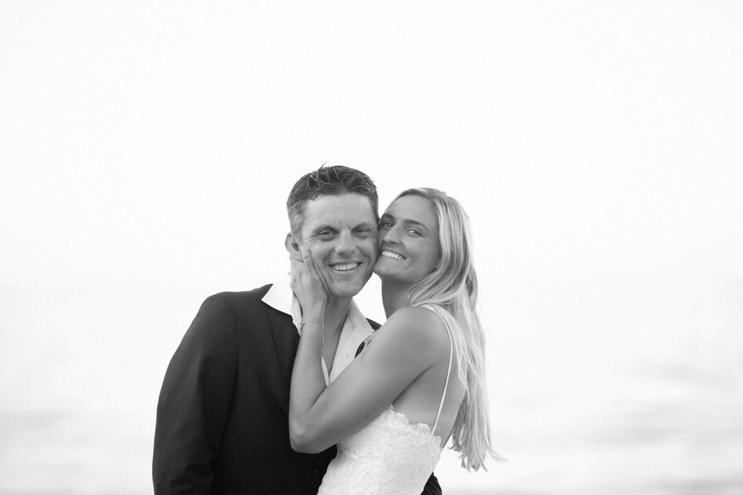A series of black and white romantic wedding photos showing tender moments between a couple.
