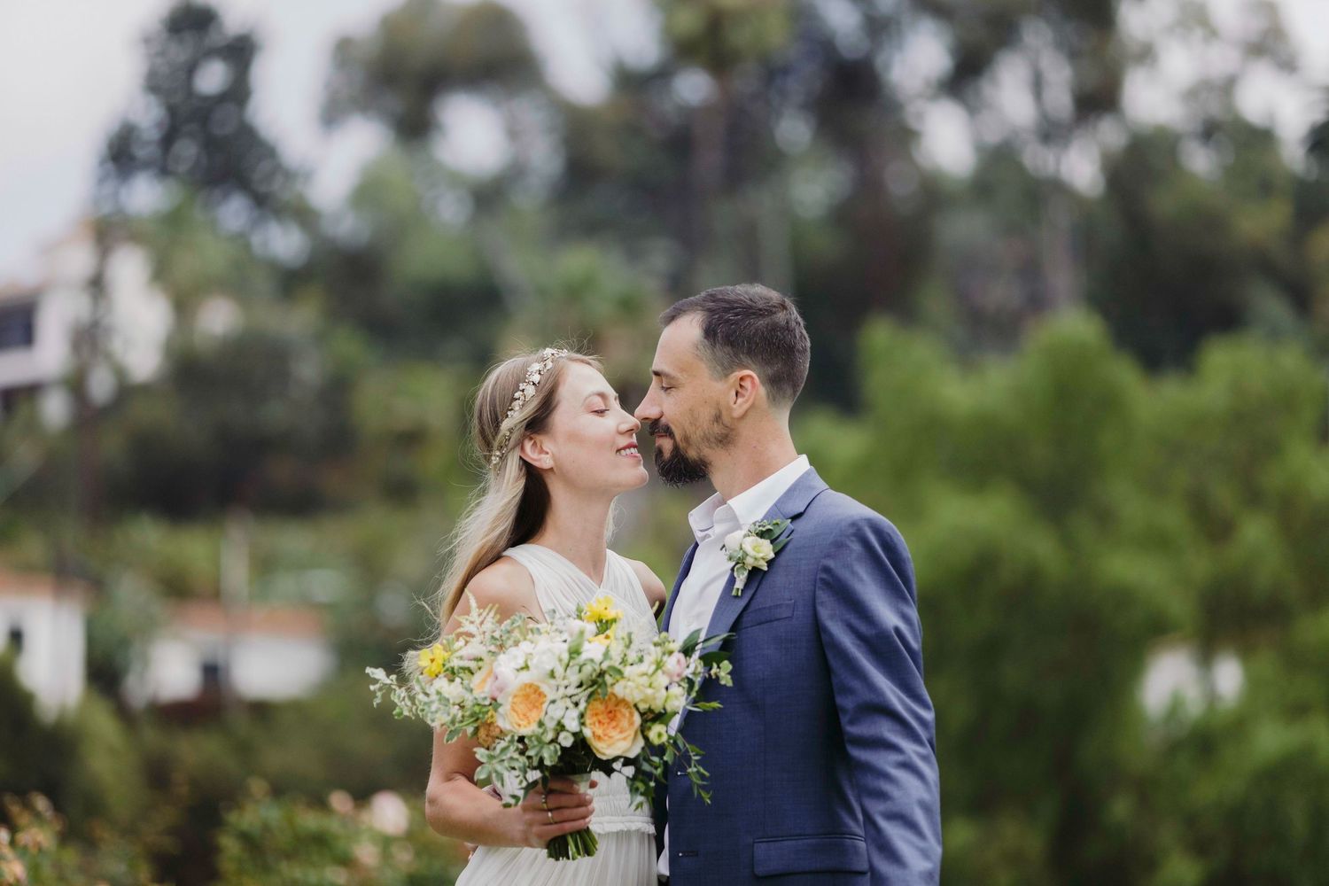 Wedding celebration in a beautiful garden setting with blooming flowers and greenery.