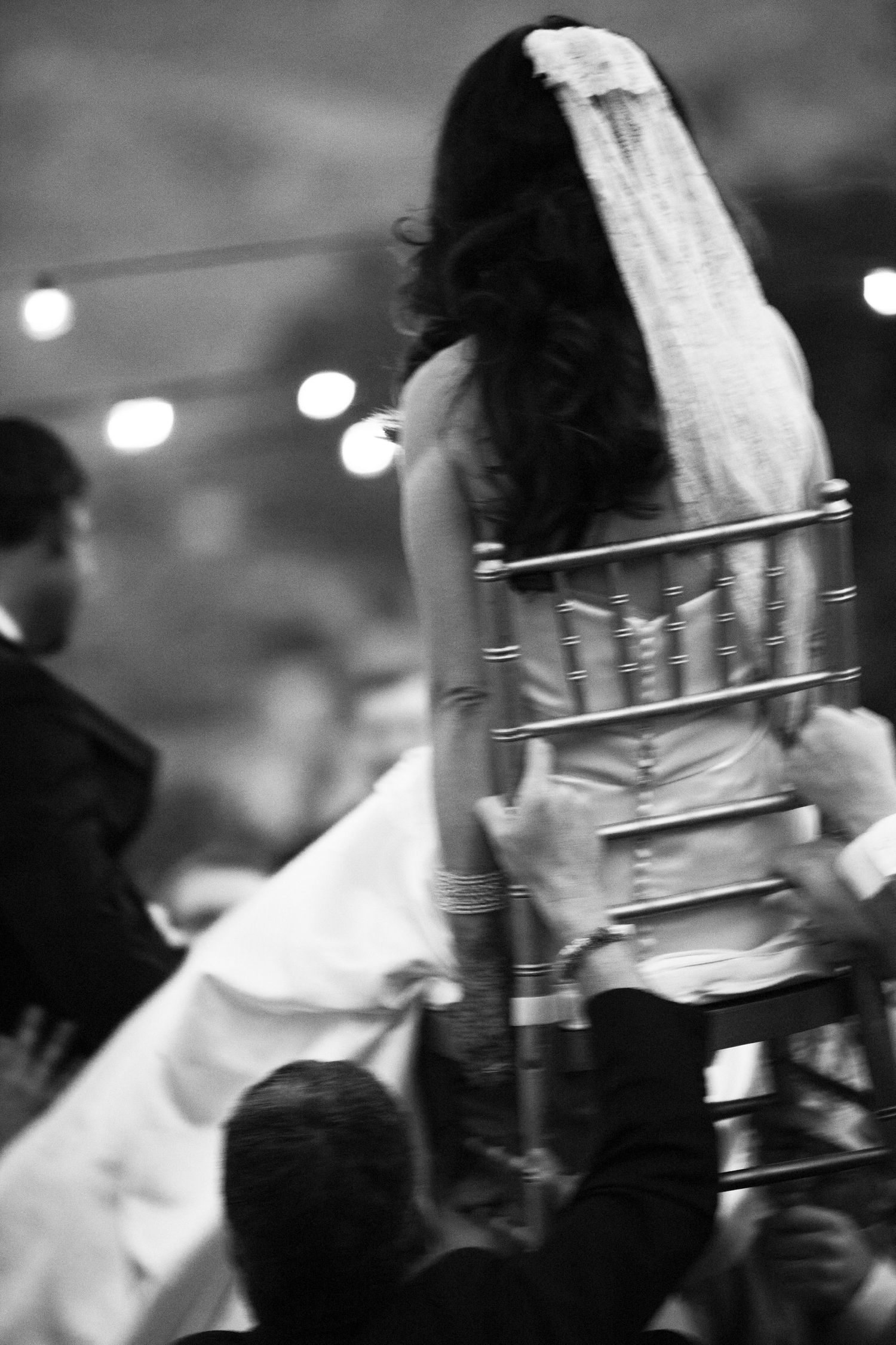 Black and white motion blur sequence shows a violin bow moving across strings during a musical performance.