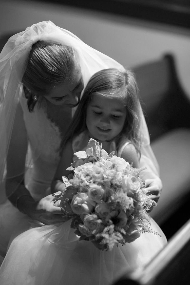 A series of black and white wedding photos showing tender moments with a bride holding a floral bouquet.