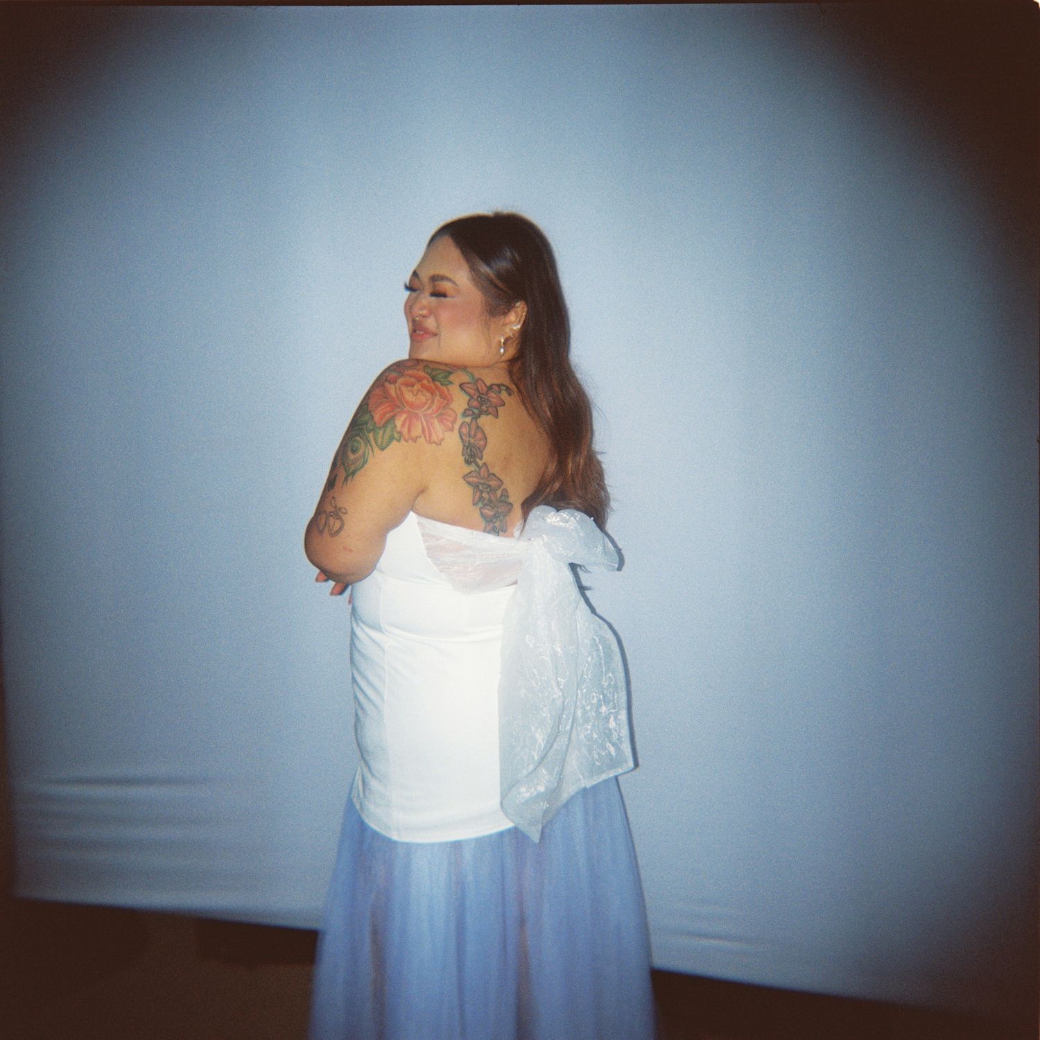 Series of photos showing a person in a white top and blue skirt against a light background.