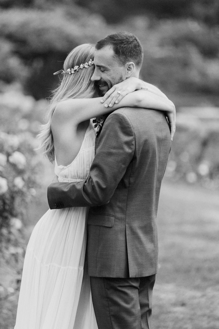 A black and white series of romantic wedding photos showing a couple embracing in an outdoor garden setting.