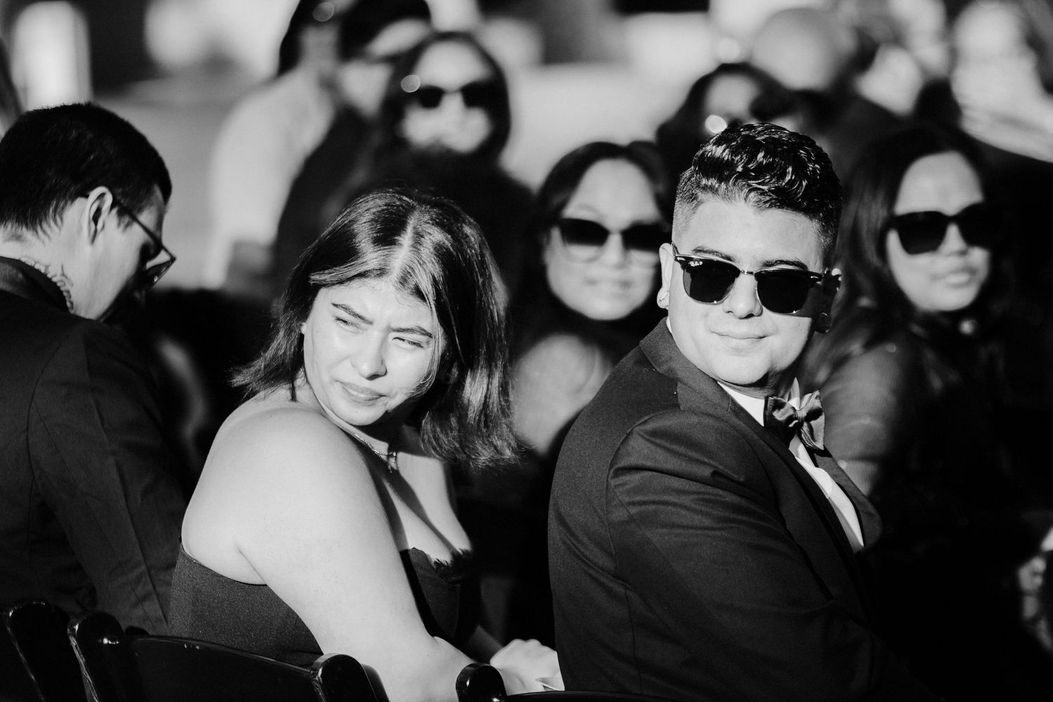 A black and white photo collage shows people wearing sunglasses at formal events.