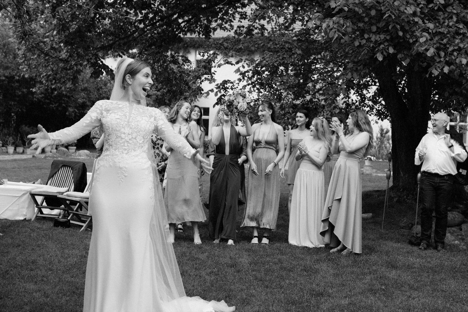 A black and white panoramic photo sequence showing moments from an outdoor wedding ceremony and reception.