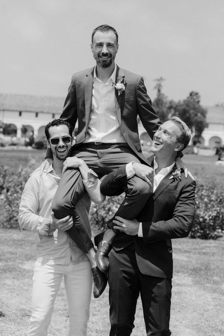 A series of black and white photos showing playful moments between wedding party members outdoors.