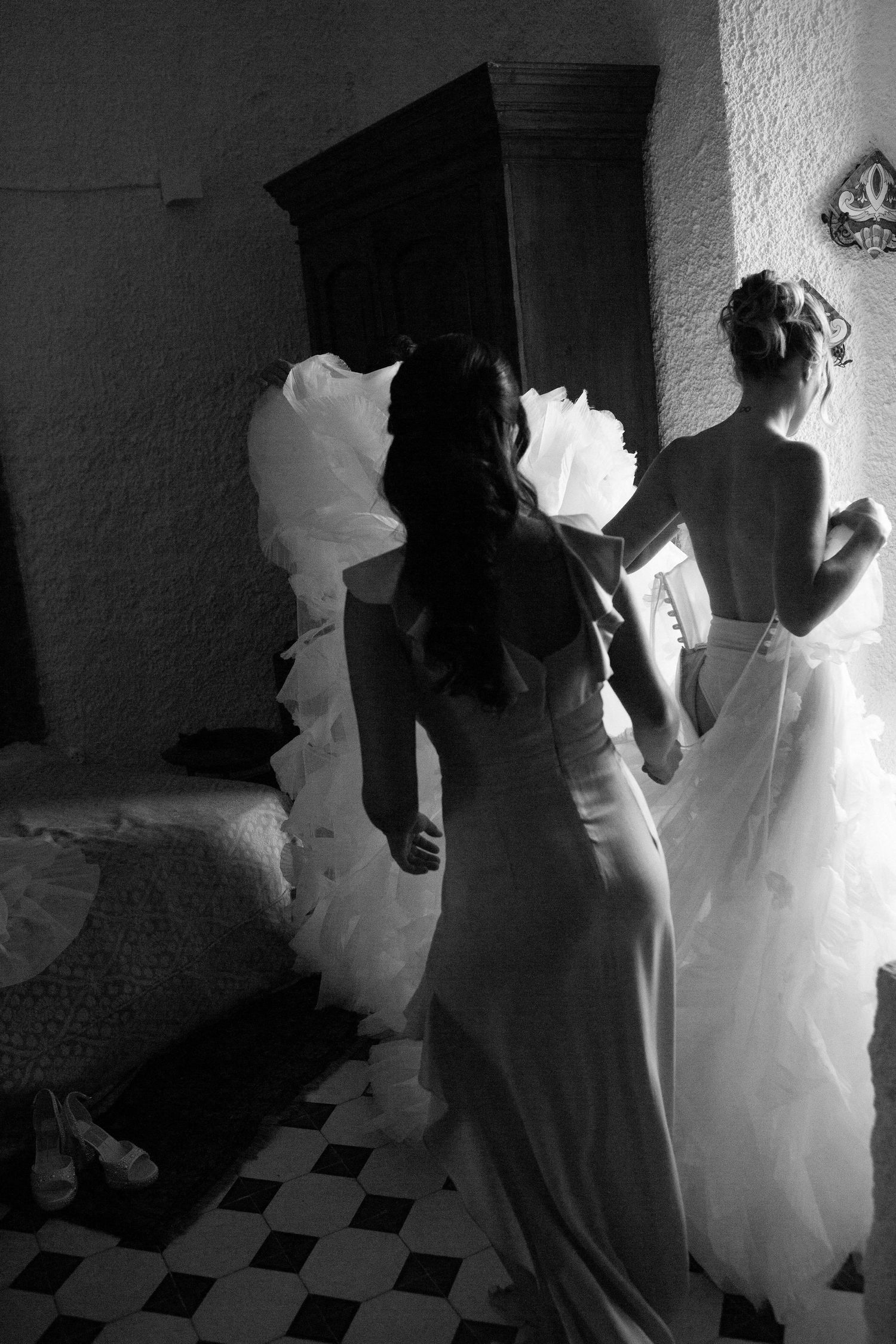 Black and white photos show silhouettes of people in formal attire dancing in sequence on a checkered floor.