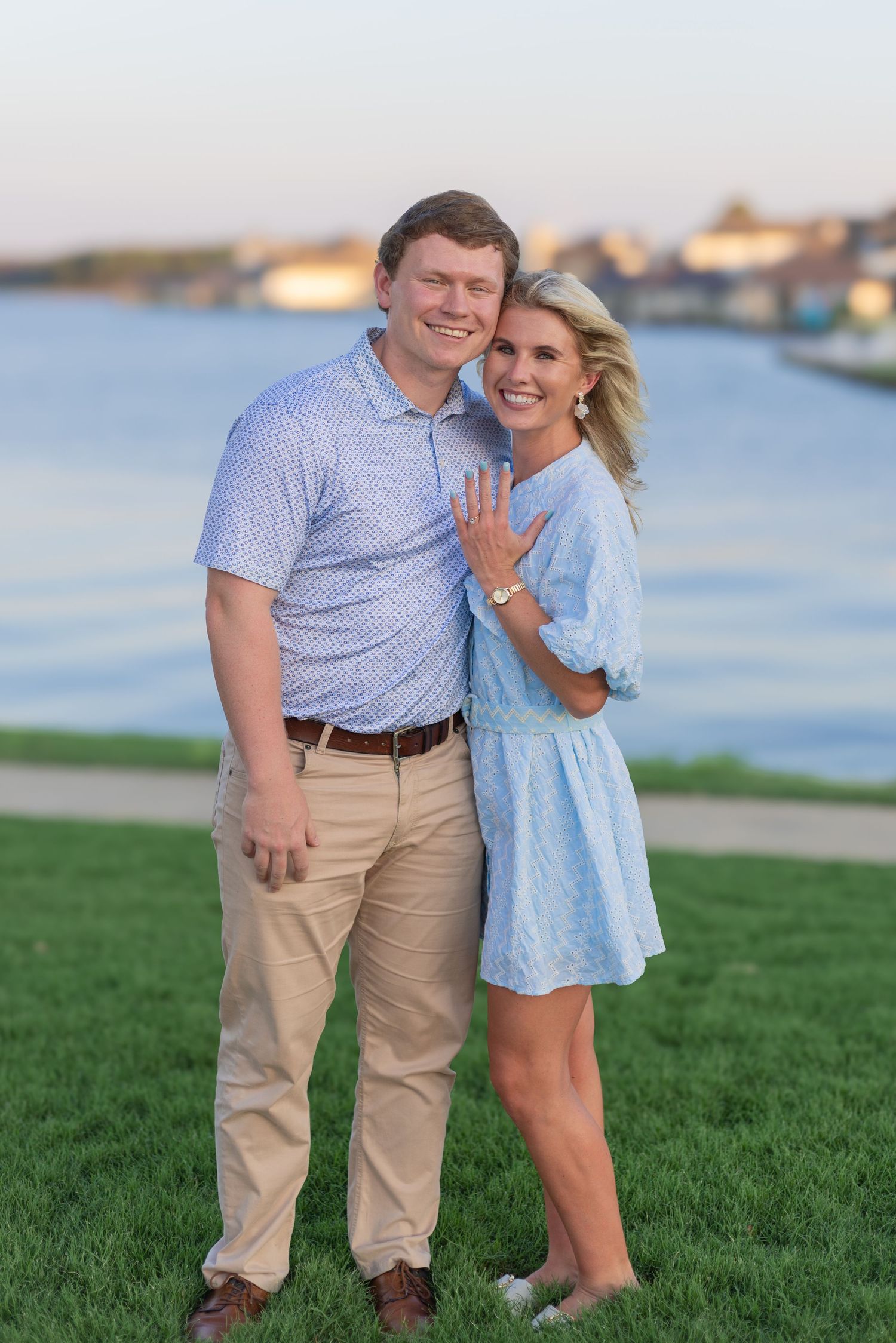Engagement photos by the water with a couple in coordinating blue and khaki outfits.