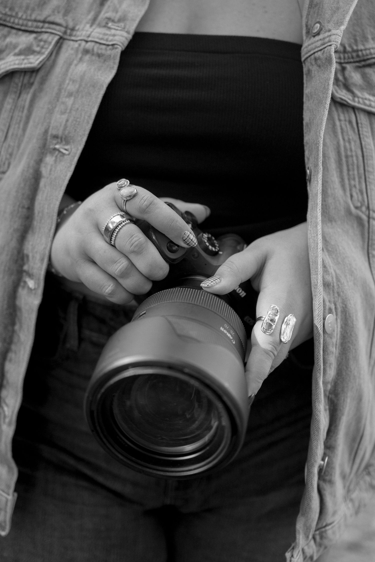 A series of black and white photos showing hands holding and adjusting camera lenses in sequence.
