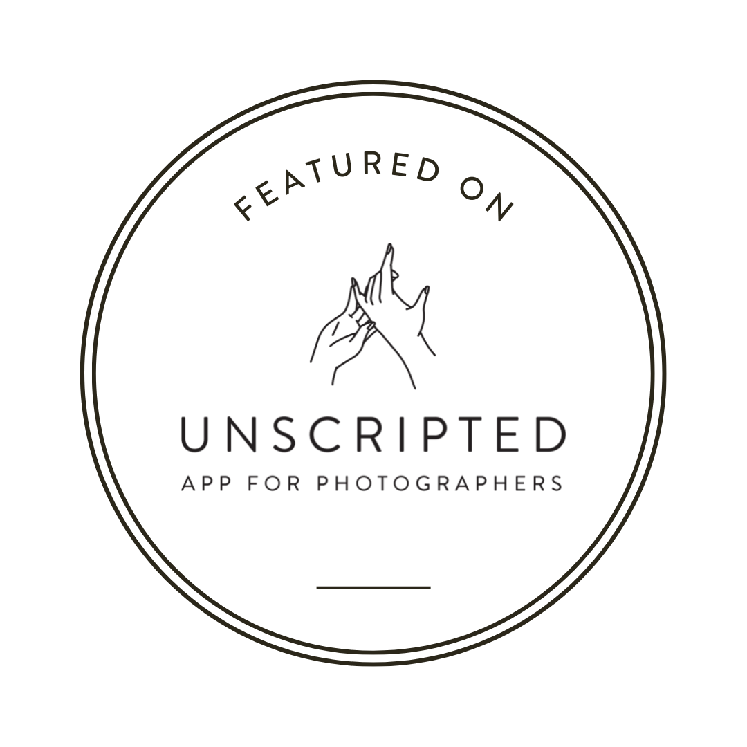 Black circular logo design for Unscripted photography app against dark background.