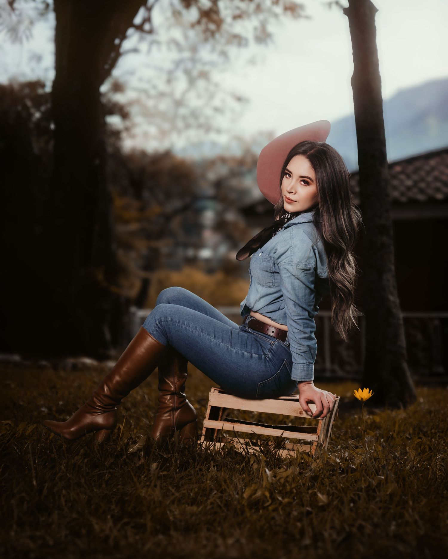 Outdoor autumn photoshoot in golden hour lighting among fallen leaves and trees.