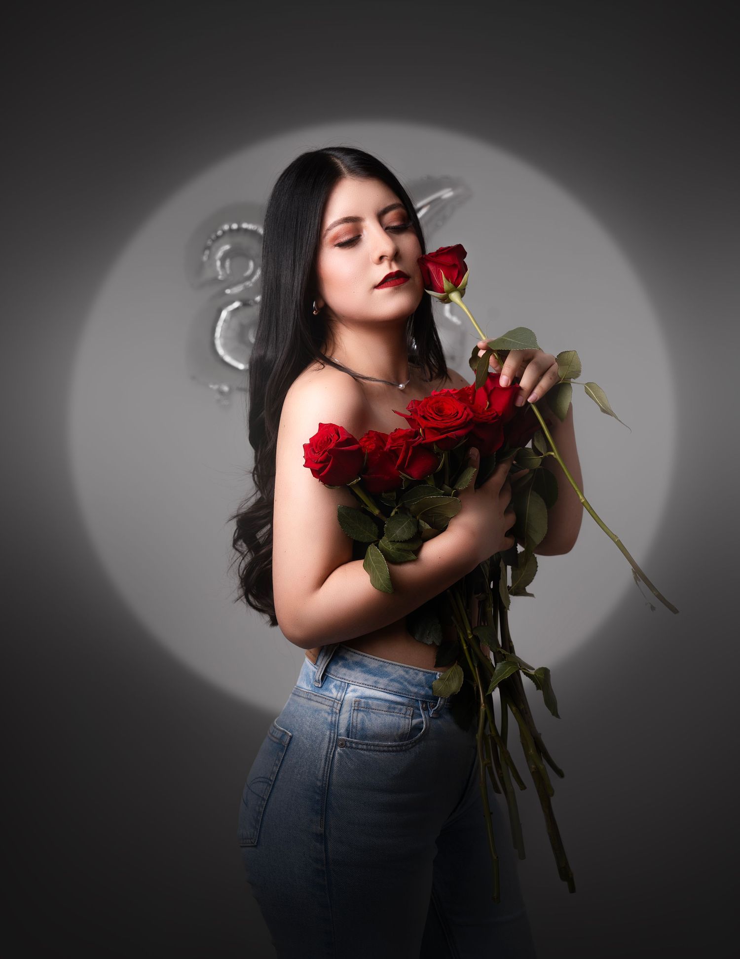 Artistic black and white portrait series with red roses against dramatic spotlight backdrop.