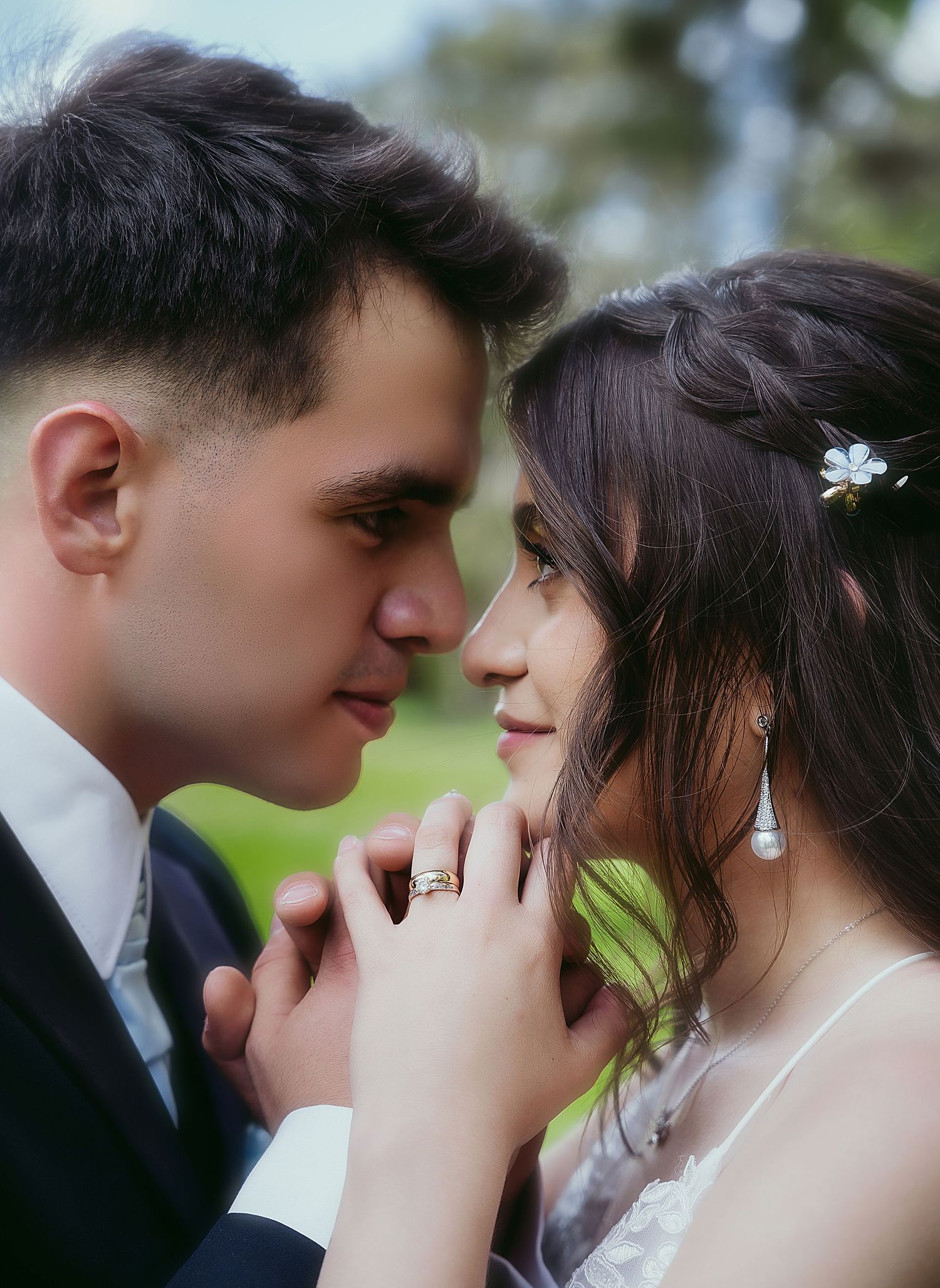A romantic wedding couple shares an intimate moment in a garden setting.
