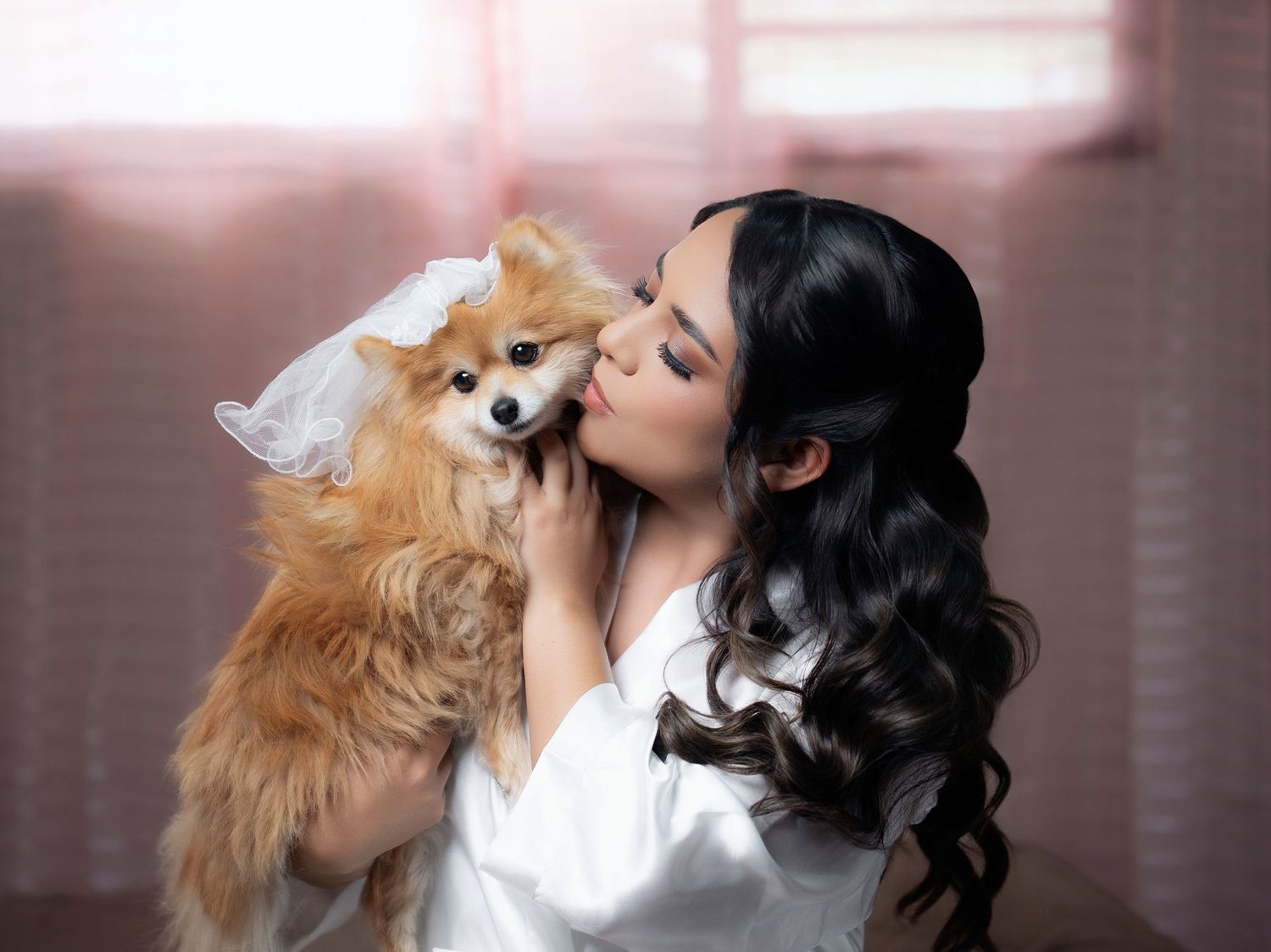 A Pomeranian dog getting kisses and affection while being held in multiple heartwarming photos.