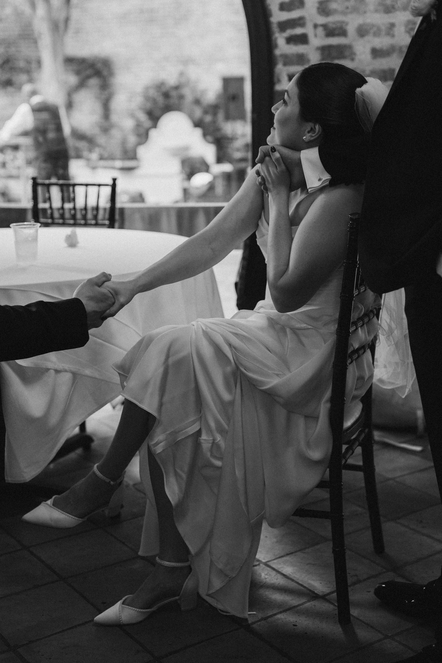 Bride holding her groom and dad hand in black and while film image in New Orleans Louisiana.