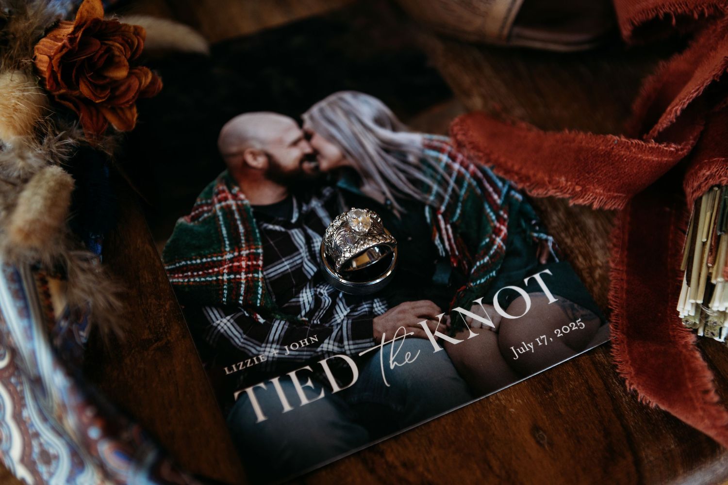 A romantic wedding magazine titled Tied the Knot dated July 13, 2025 with engagement rings resting on top.