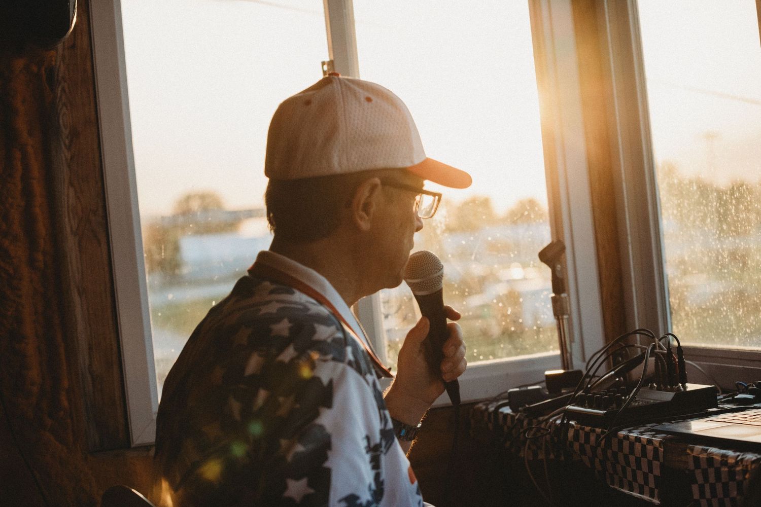 Rodney Tomlinson announces live at a racing event, representing Tomlinson Announcing with professional sports commentary