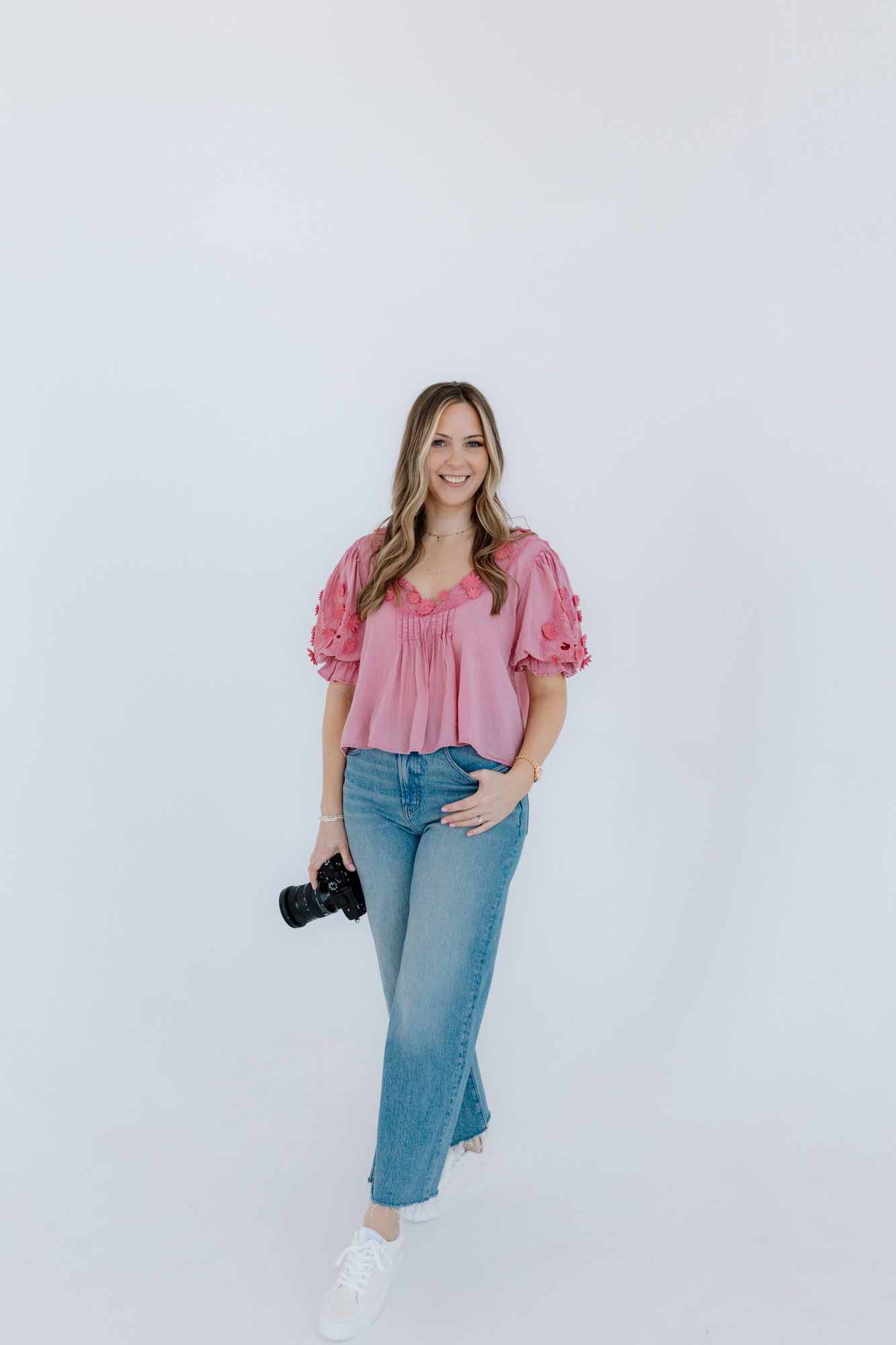 Lifestyle portrait in pink top and jeans against white studio background Chattanooga Branding