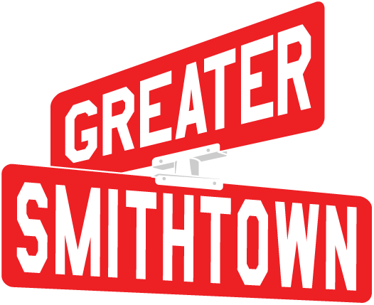 A red and white street sign design reading 'GREATER SMITHTOWN' with bold text on angled panels.