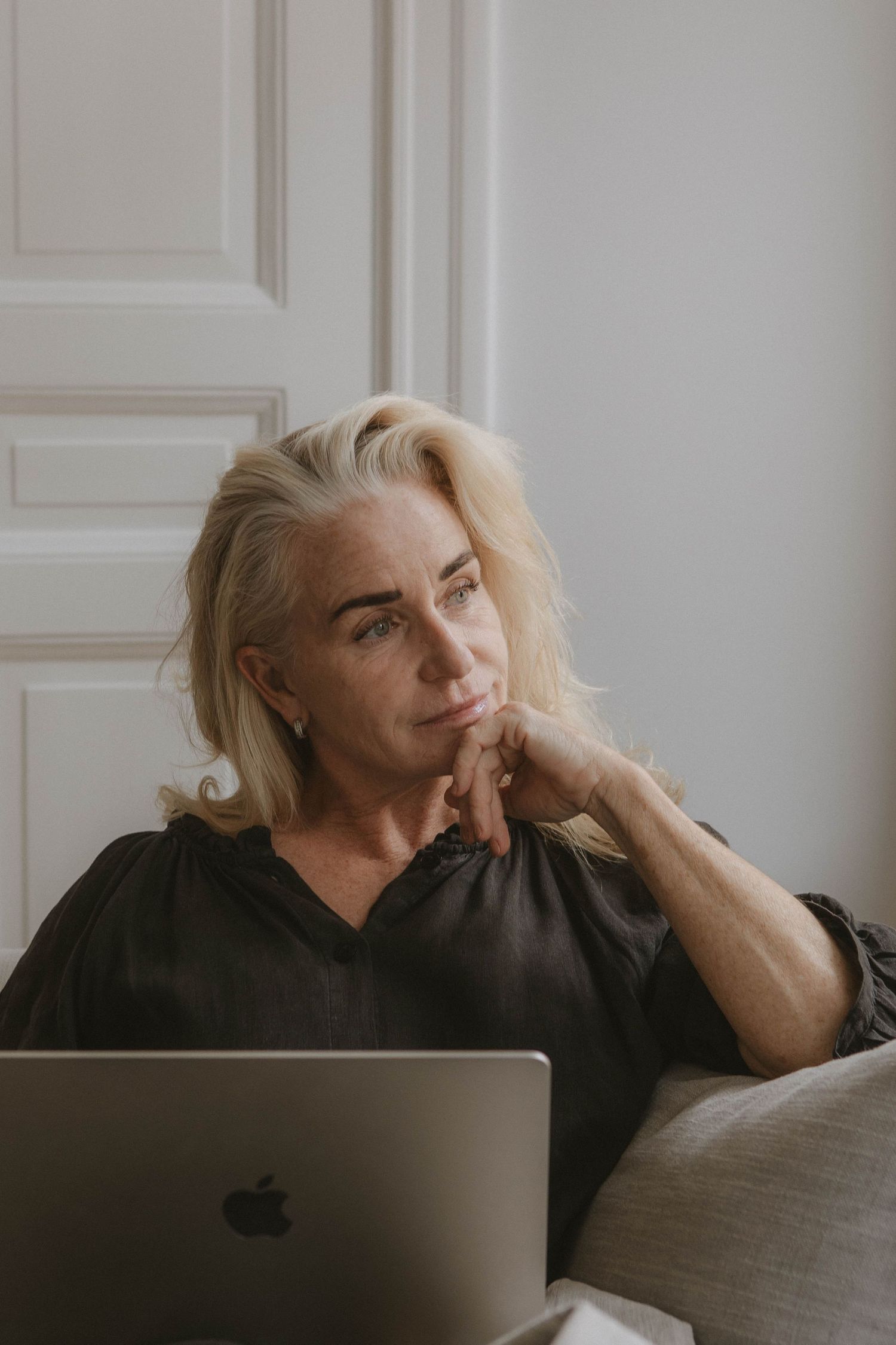 Person working from home relaxes with laptop in comfortable setting.