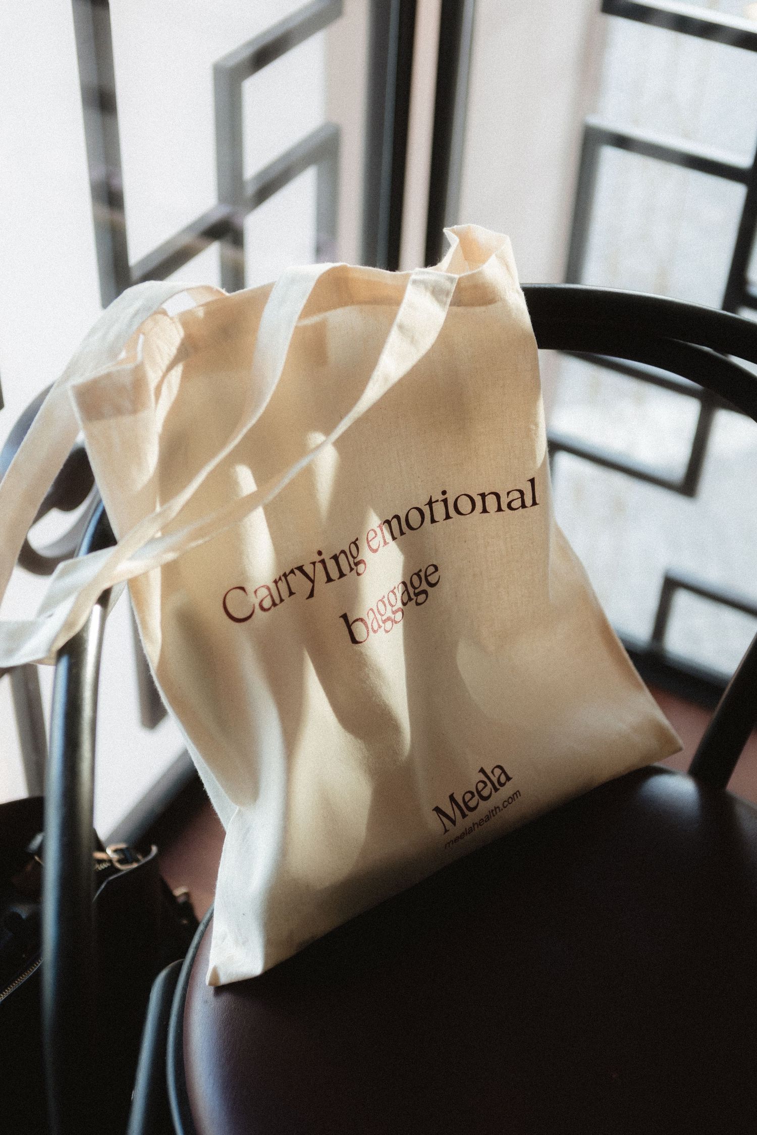 Row of white paper bags with text arranged on a dark surface in soft lighting.