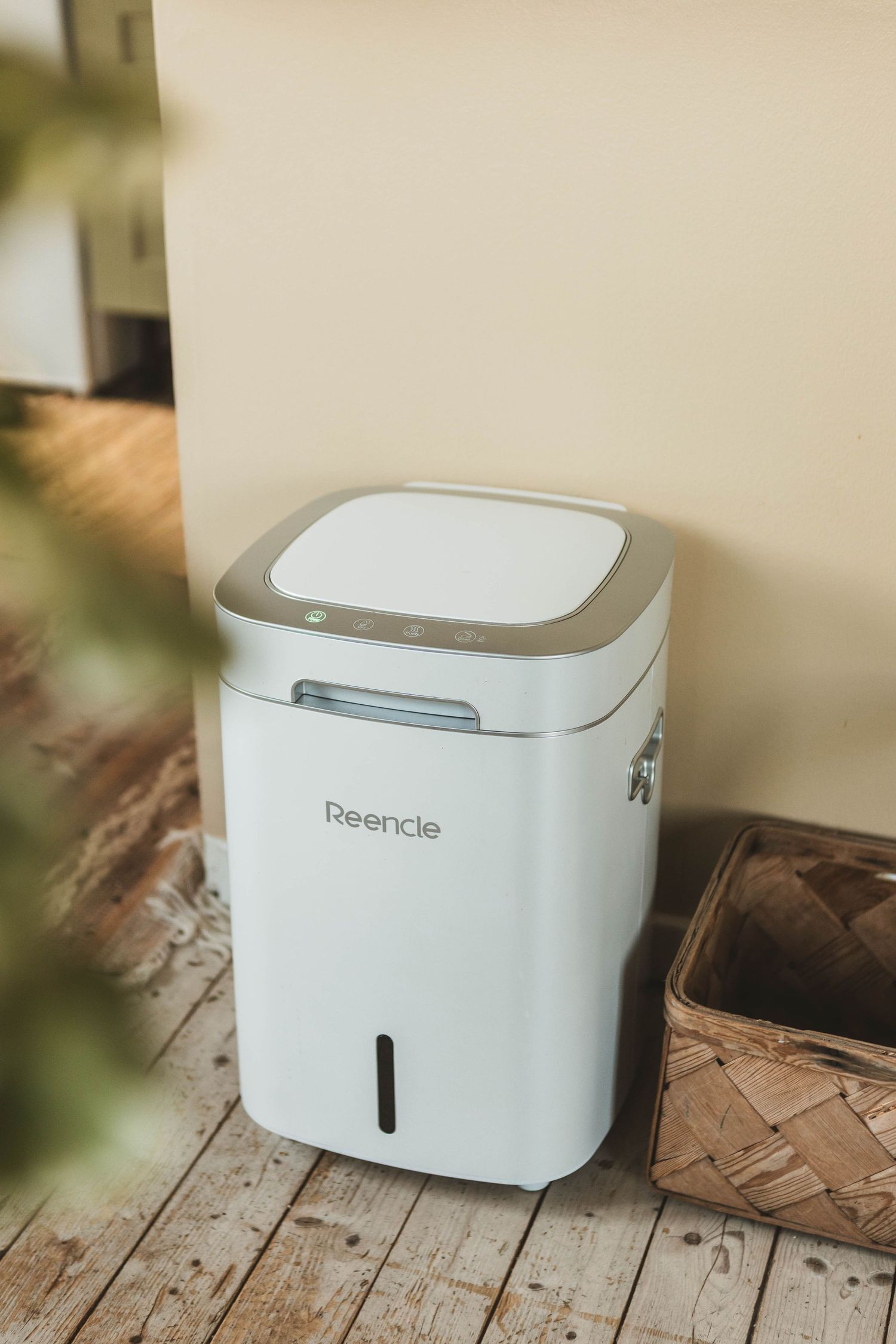 Sleek white smart trash can with modern design shown at various angles on wooden flooring.