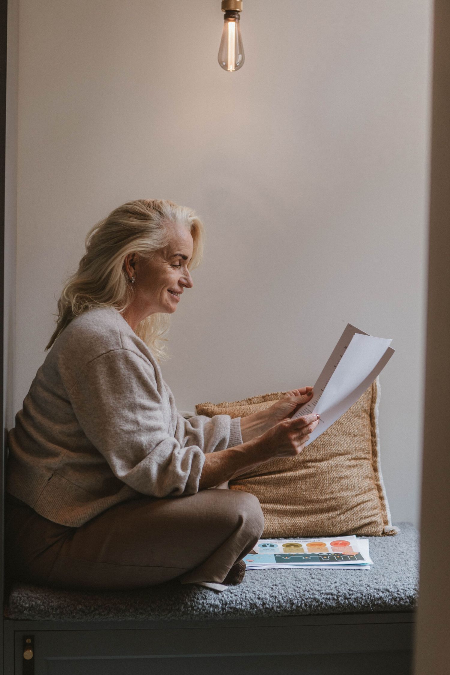 Comfortable reading nook scene with book and coffee by window.