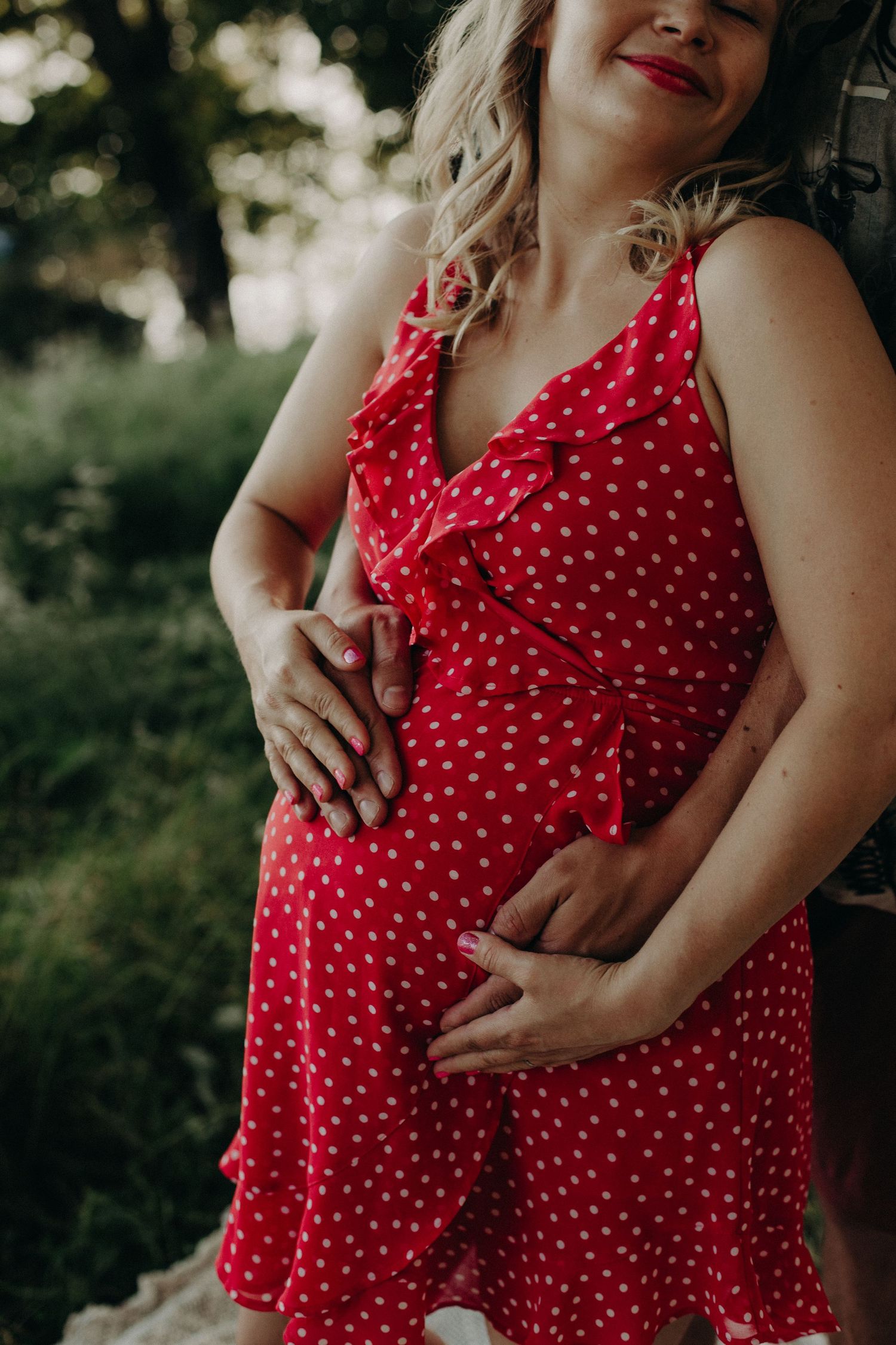 Close-up shots of a red polka dot dress against natural outdoor lighting.