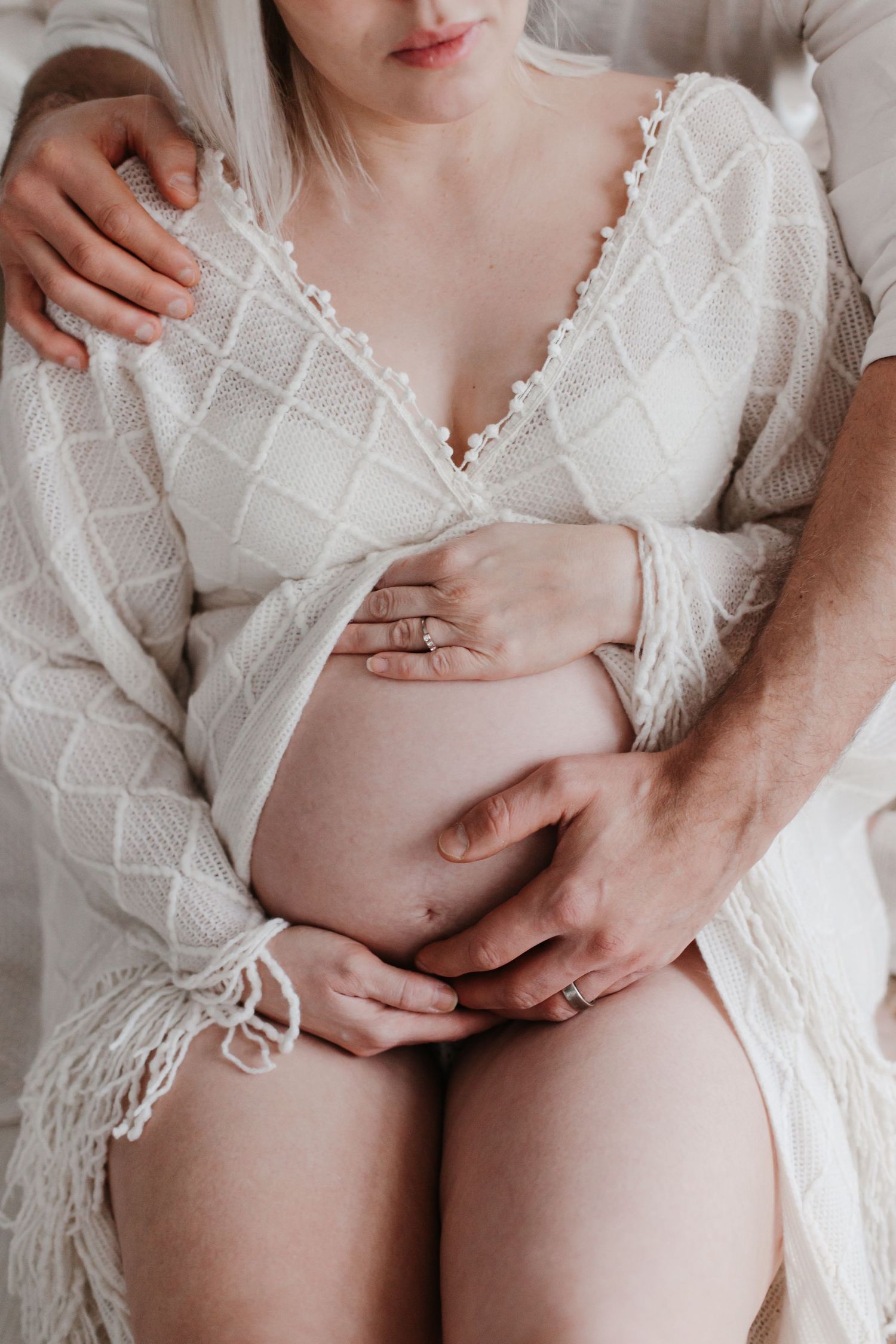 Close-up maternity photo showing delicate white lace details.