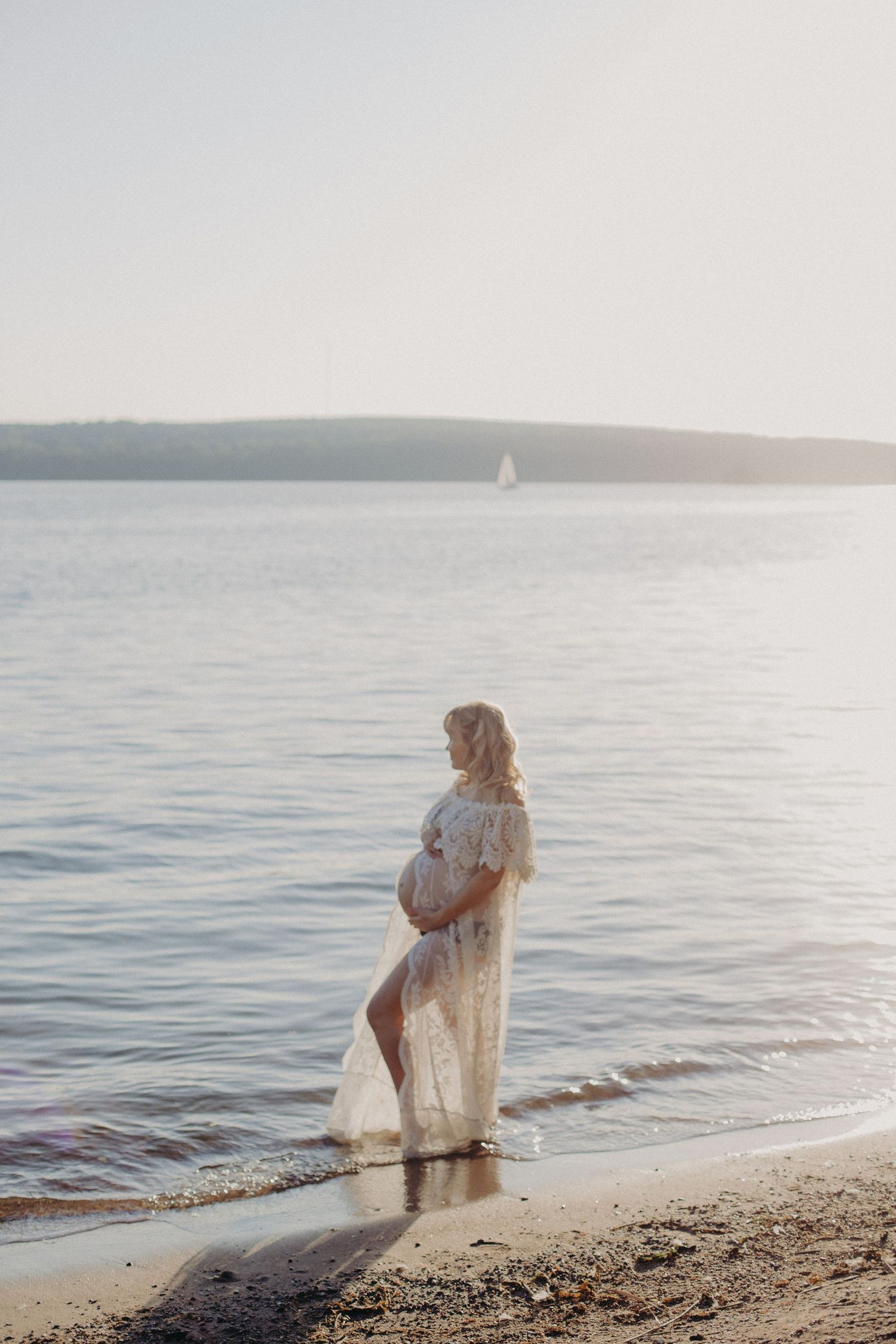 Artistic maternity photography sequence at the beach with waves and soft evening light.