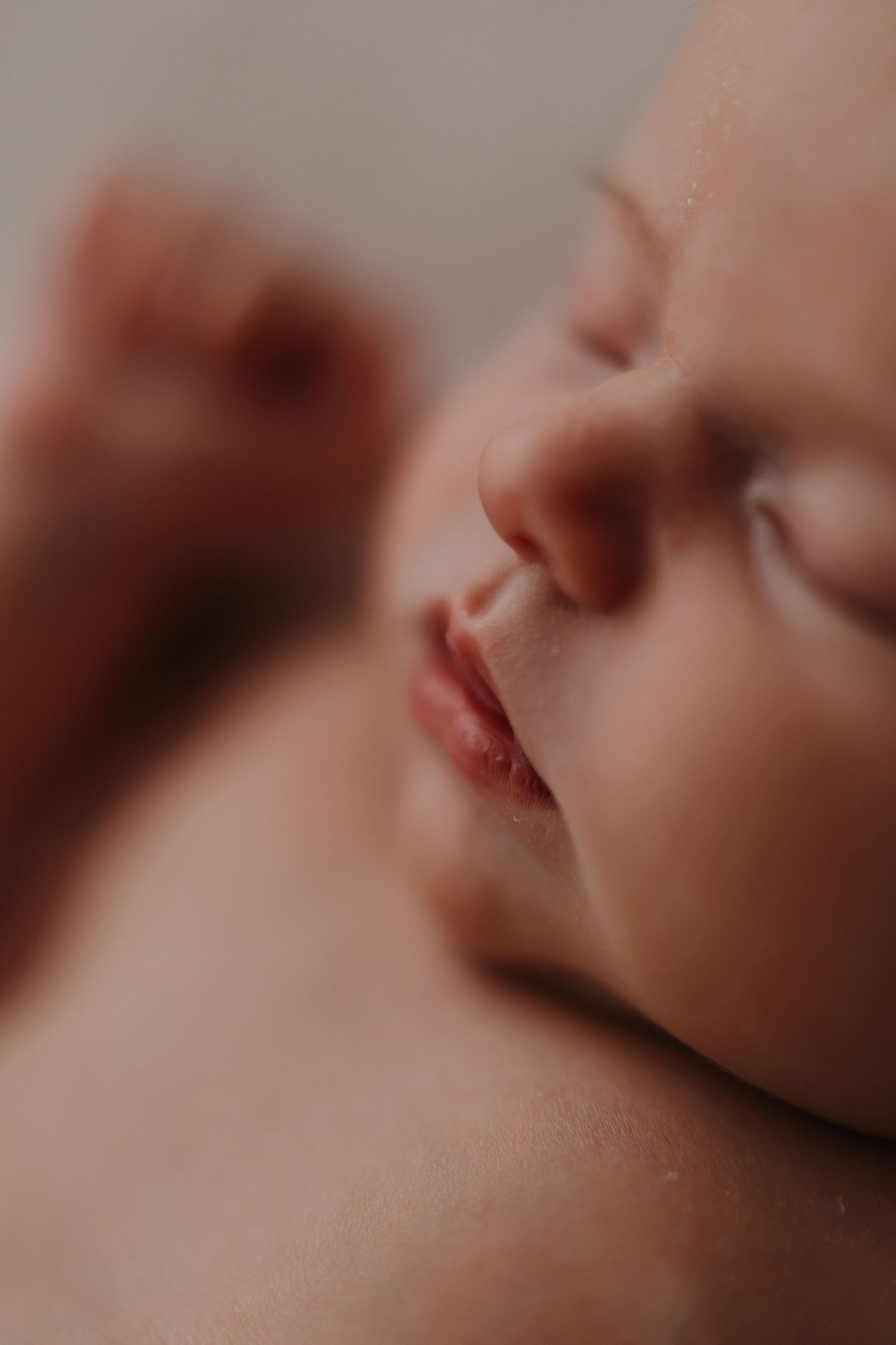 Macro shot of sleeping newborn's nose and lips.