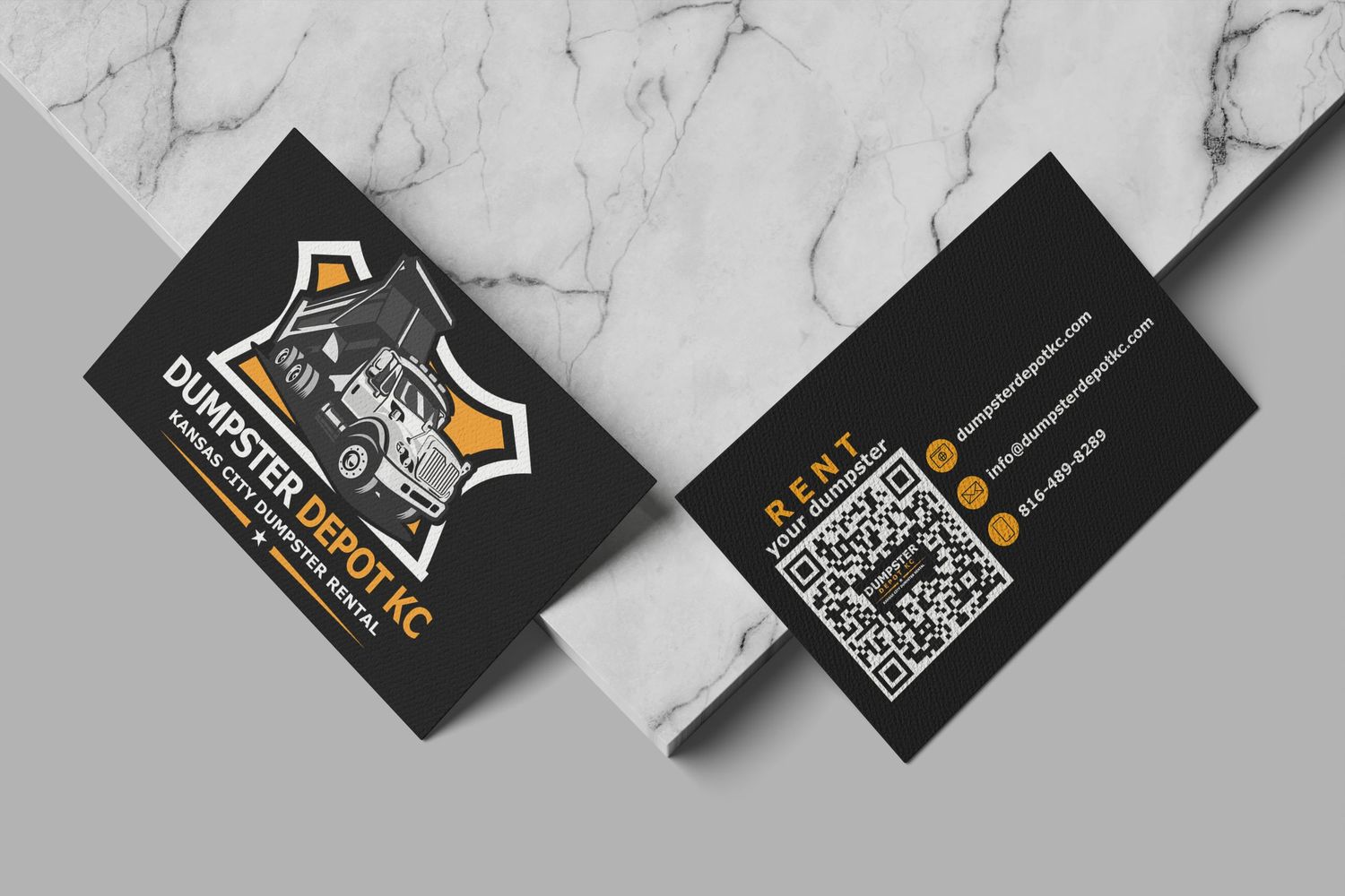 Bold black business cards for Dumpster Depot KC with orange logo and QR code on marble surface.