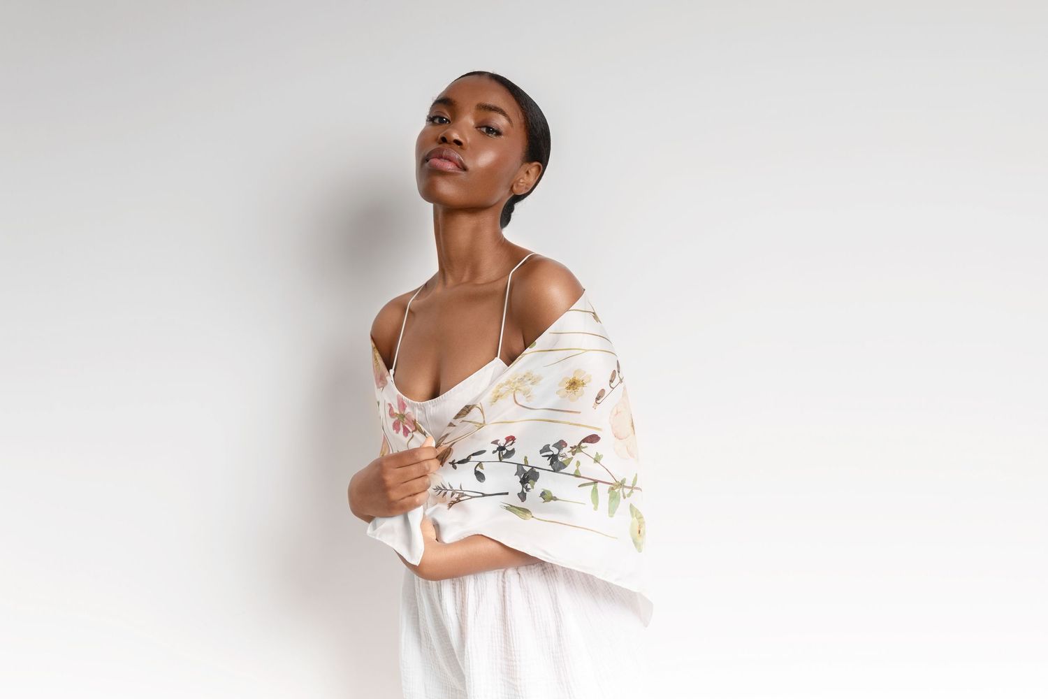 Ethereal fashion portraits against white background in flowing white garments.