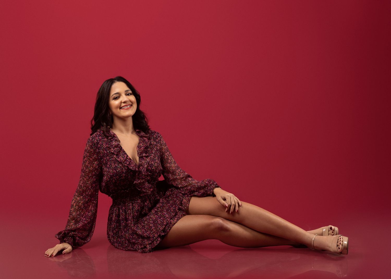 Fashion series on red background featuring burgundy floral dress and elegant poses.