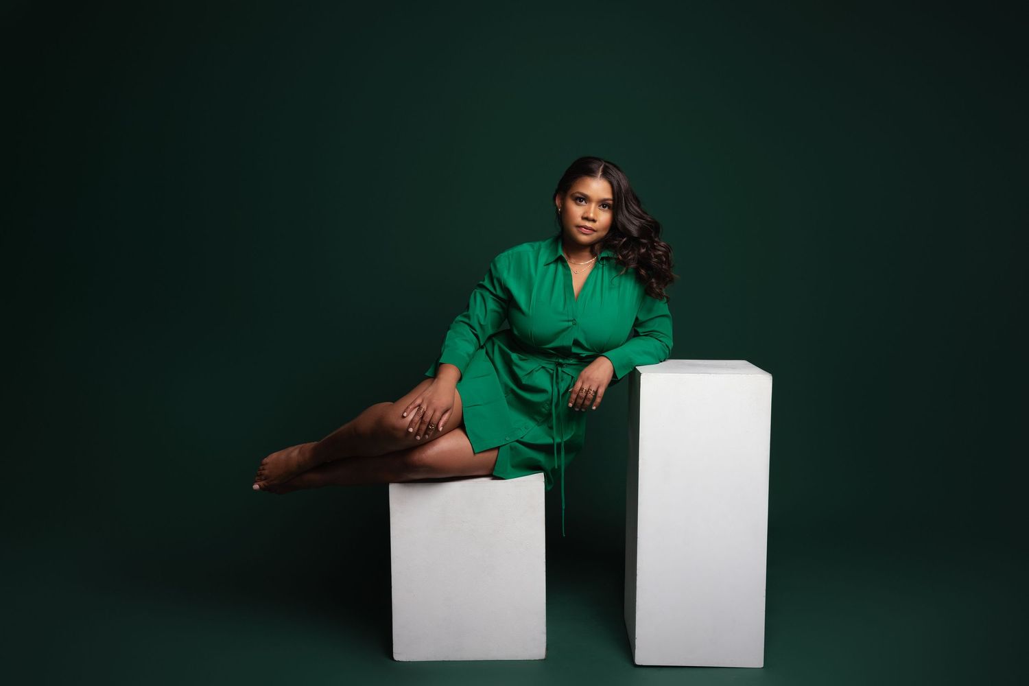 Modern fashion portraits with white geometric blocks against dark green background.