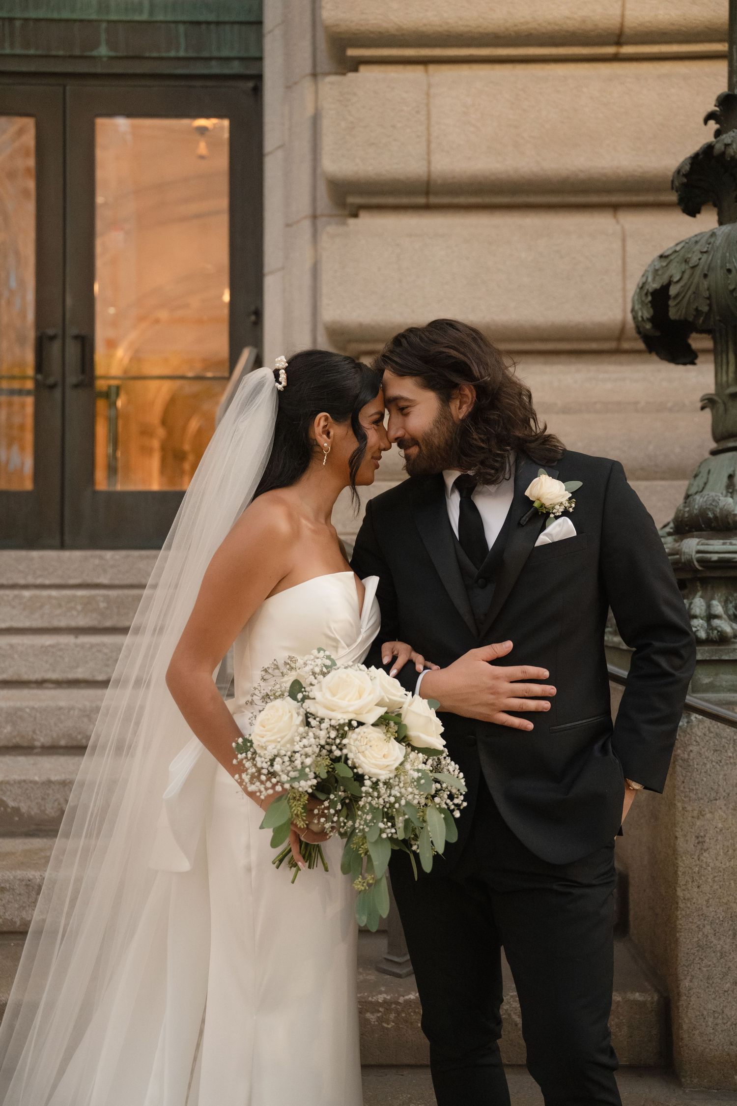 A romantic wedding photo sequence showing tender moments between newlyweds outside a historic building.