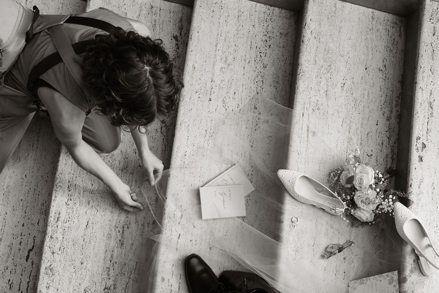 Black and white image showing Alexa P. Artistry's hands setting up wedding details