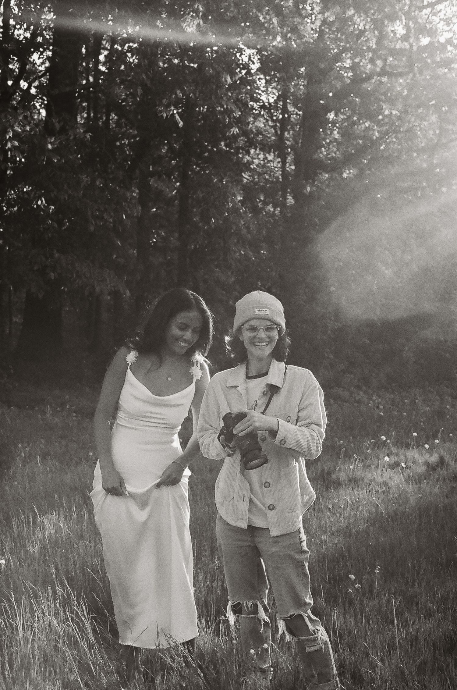 Alexa P. Artistry working in a sunlit field setting during a couples session.