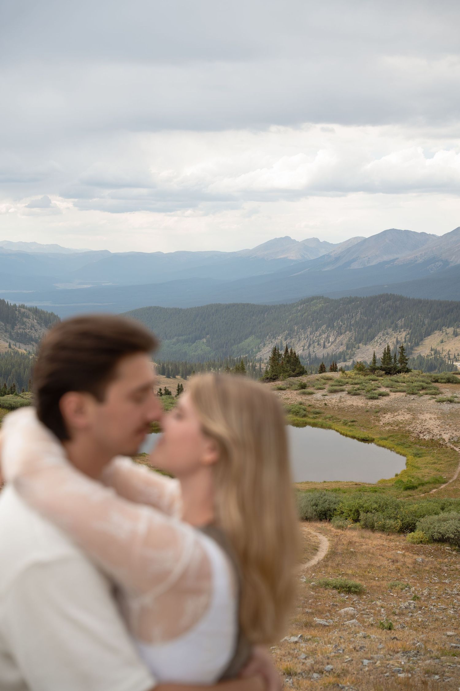 Scenic Colorado mountain landscape with couple sharing intimate moment.
