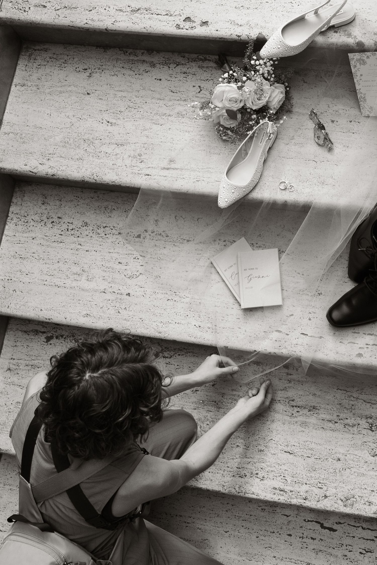 Black and white image showing Alexa P. Artistry's hands setting up wedding details