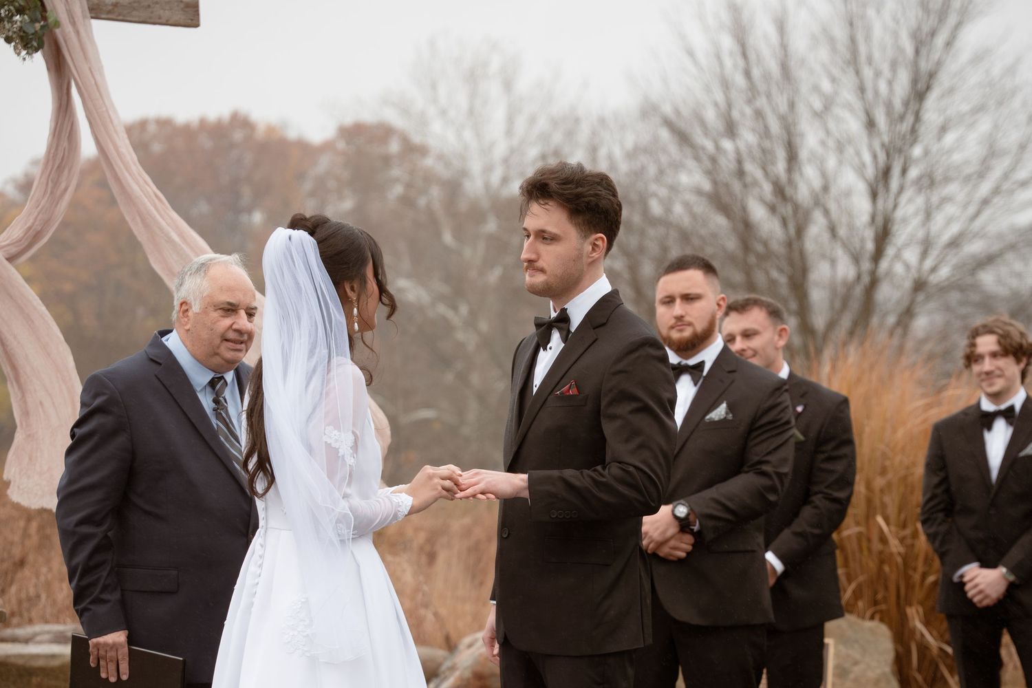 Bride and Groom exchange rings during an outdoor autumn ceremony in Ohio.