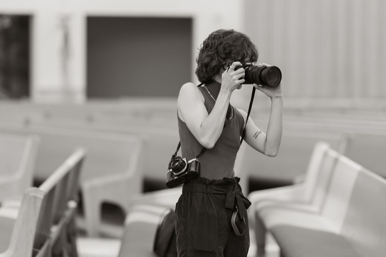 Alexa P. Artistry working during an indoor church wedding. Black and White