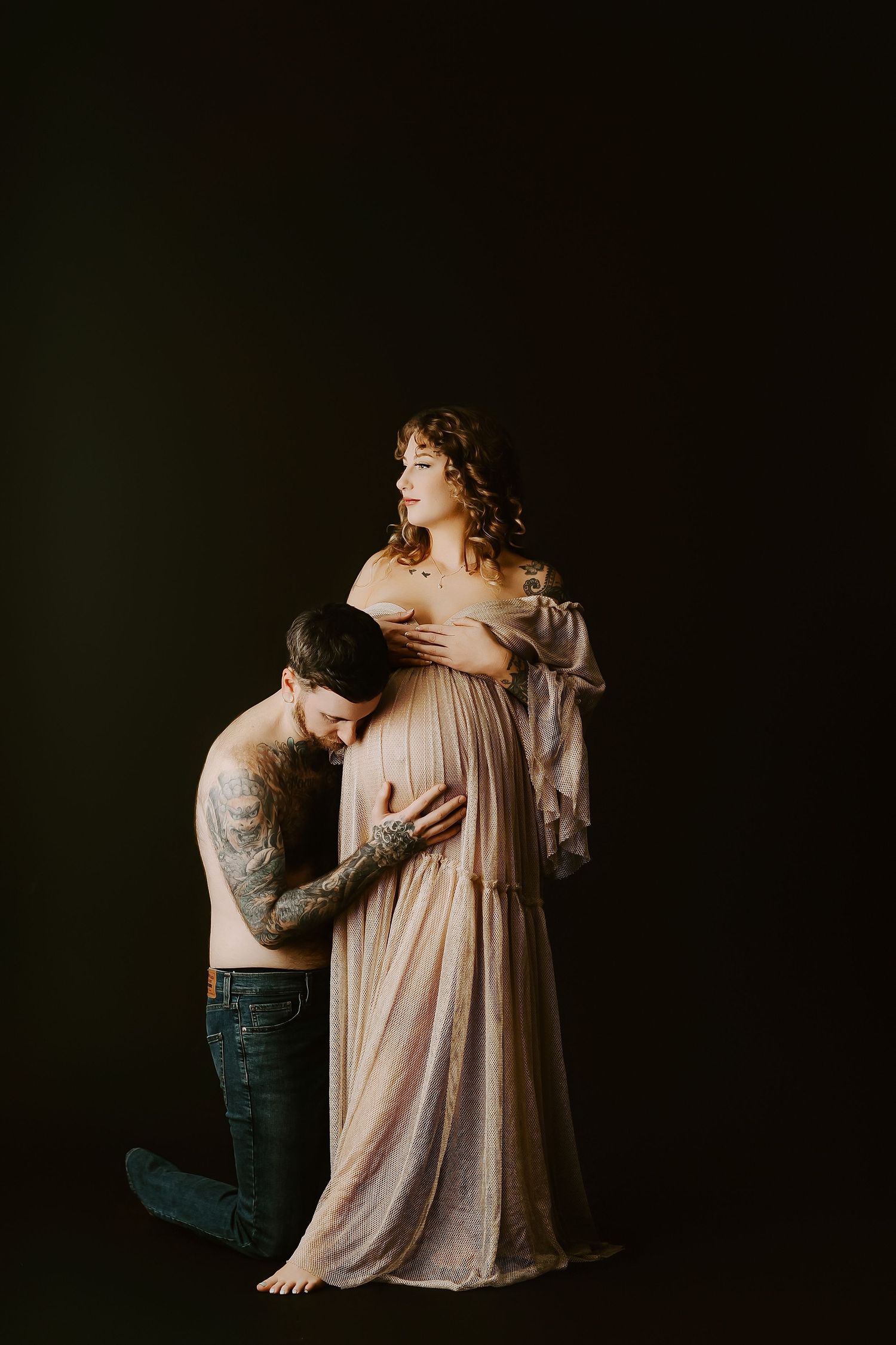 Intimate maternity portraits in muted tones featuring gentle poses and soft lighting against a dark background.