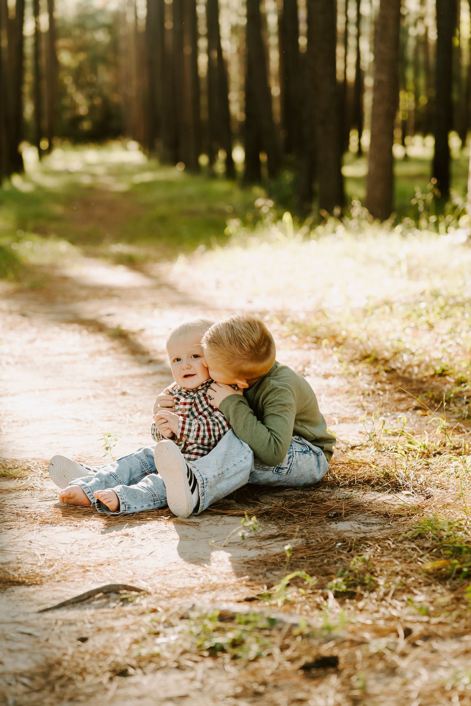 Sweet candid moments captured between family members on a forest trail.