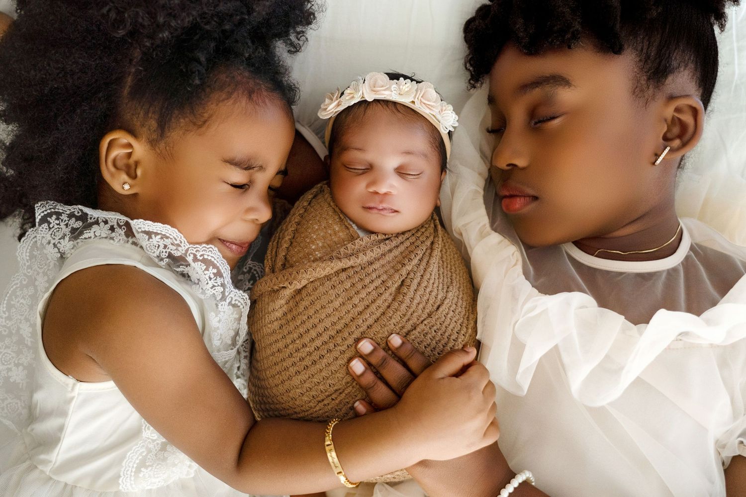 Series of tender newborn portraits featuring soft brown wraps and delicate lace accessories.