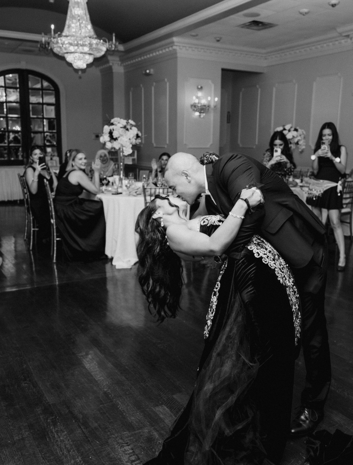 Black and white photos of wedding guests dancing energetically at reception.