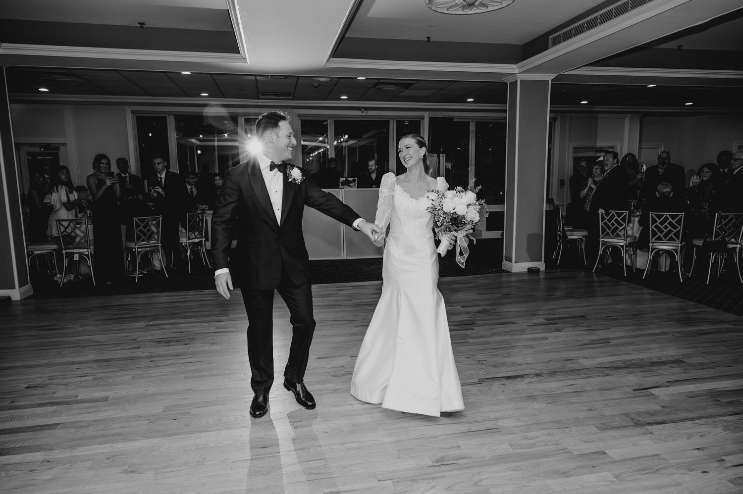 A series of black and white photos showing a couple dancing together at a wedding reception.