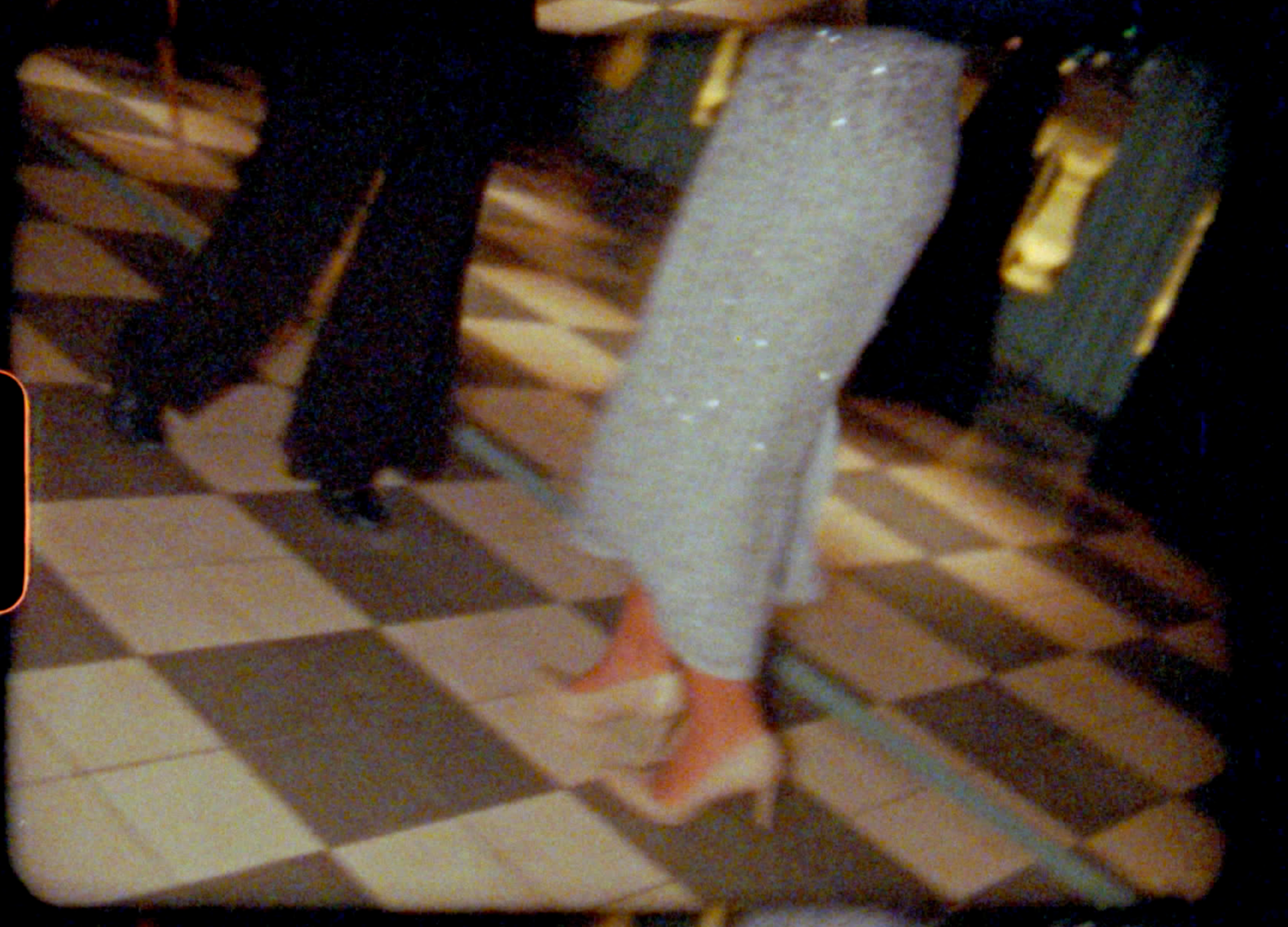 A person walking across a tiled floor wearing gray pants and pink shoes, shown in multiple sequential frames.
